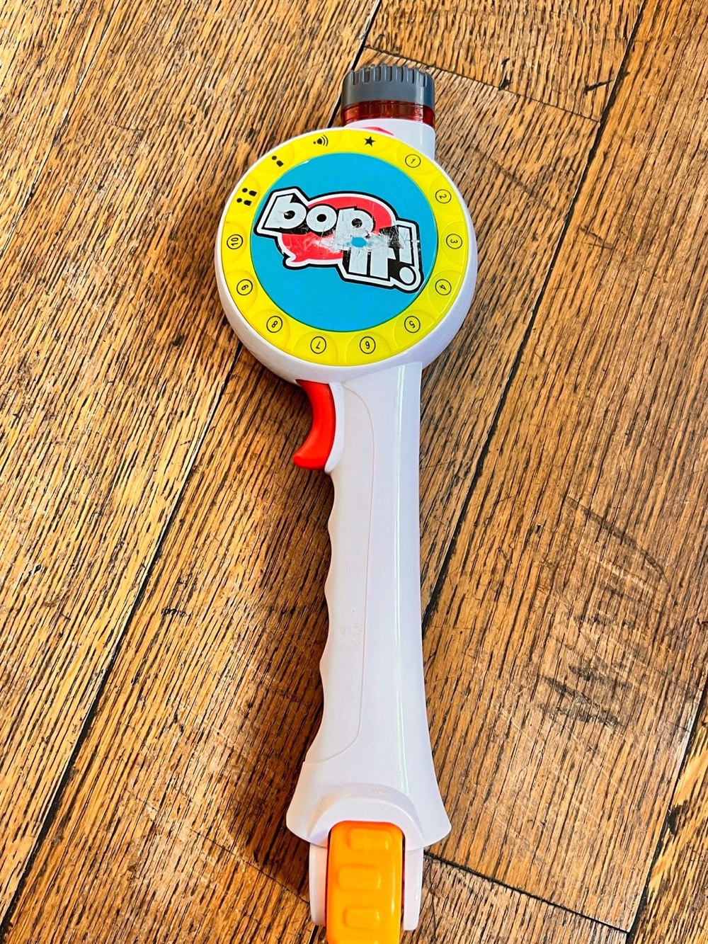 Hasbro Bop It! Handheld Game in White with Yellow, Blue & Red Accents
